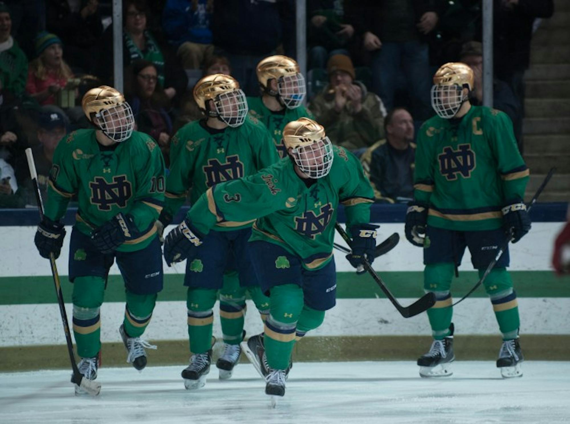 The Notre Dame hockey team celebrates after a goal against Boston College on Feb. 28. The Irish beat Guelph in an exhibition of the season on Friday at Compton Family Ice Arena.