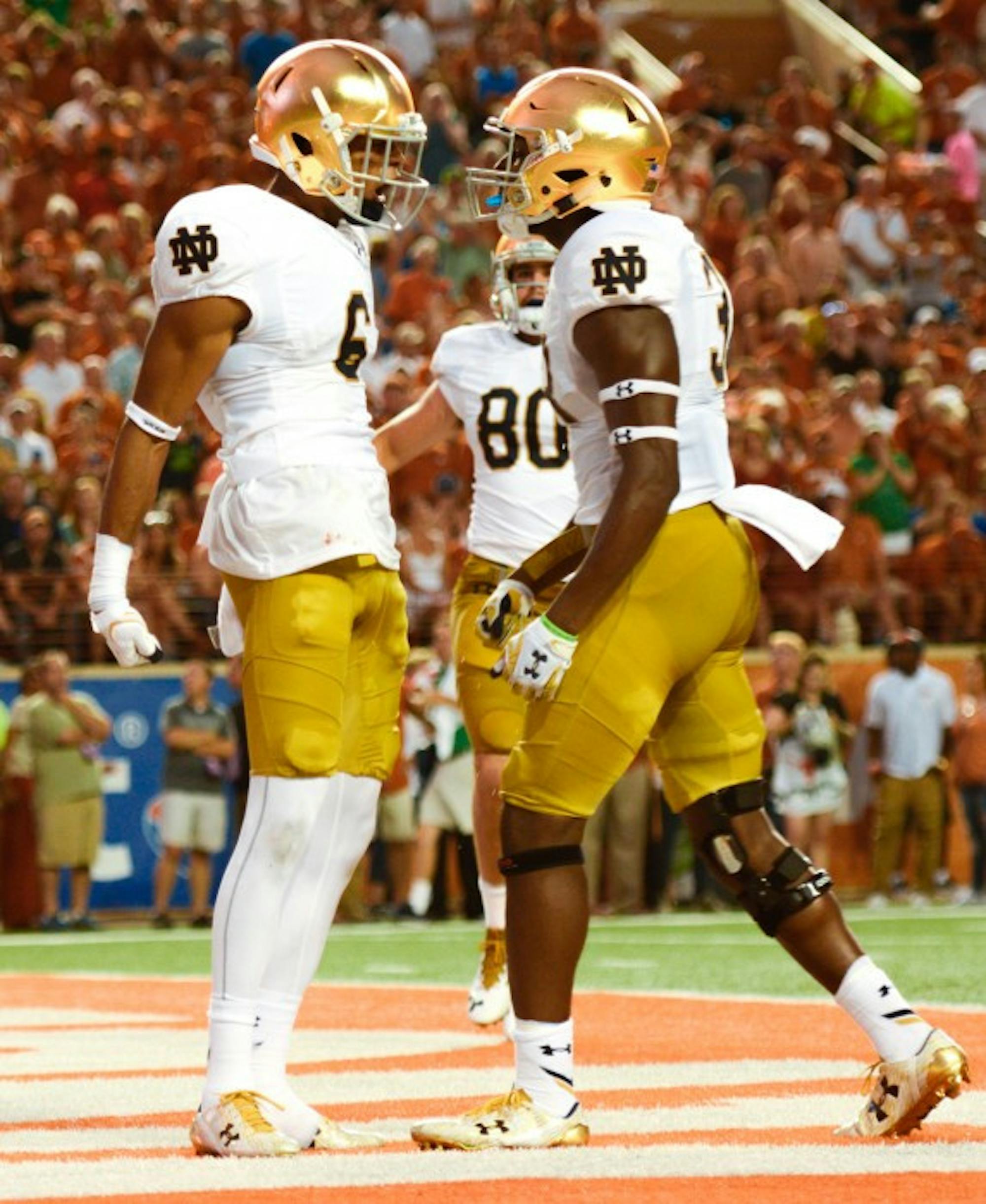 Irish sophomore receiver Equanimeous St. Brown (left) celebrates one of his two touchdowns against Texas Sunday night during Notre Dame's 50-47 loss.