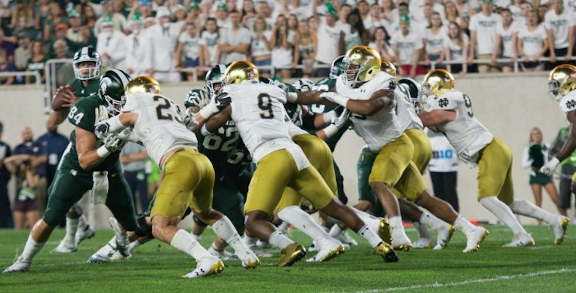 Irish sophomore defensive lineman Daelin Hayes, second from the left, fights against a block during Notre Dame’s 38-18 victory over Michigan State on Sept. 23 at Spartan Stadium in East Lansing, Michigan. Hayes has recorded 14 tackles and two sacks this season. Hayes played in all 12 games last season after suffering multiple injuries in high school.