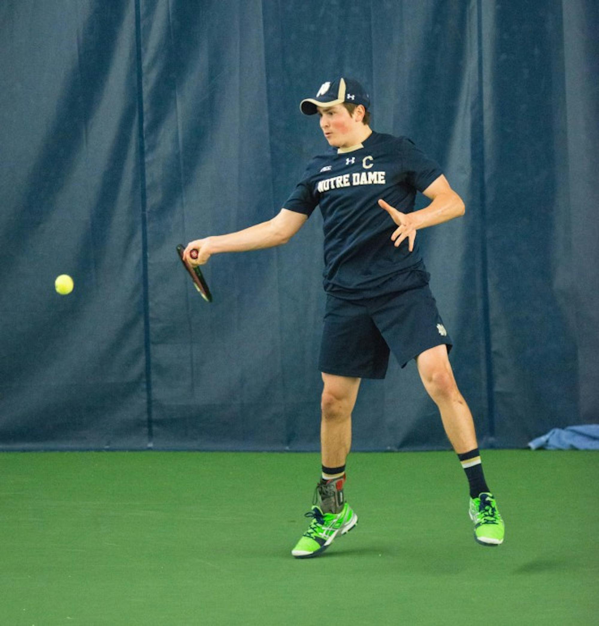 Junior captain Quentin Monaghan looks to hit a forehand during a 4-3 win over Oklahoma State on Jan. 21.