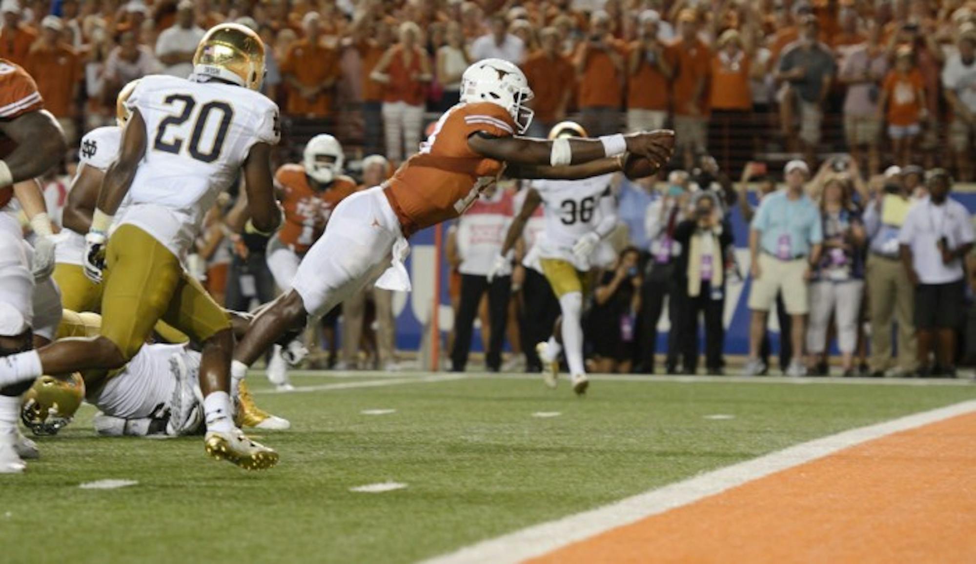 Longhorns senior quarterback Tyrone Swoopes dives into the end zone to secure Texas a 50-47 victory over Notre Dame at Darrell K. Royal-Texas Memorial Stadium on Sunday. Both teams scored touchdowns in the first overtime period before Texas held the Irish to a field goal and scored the winning touchdown in the game’s second overtime.