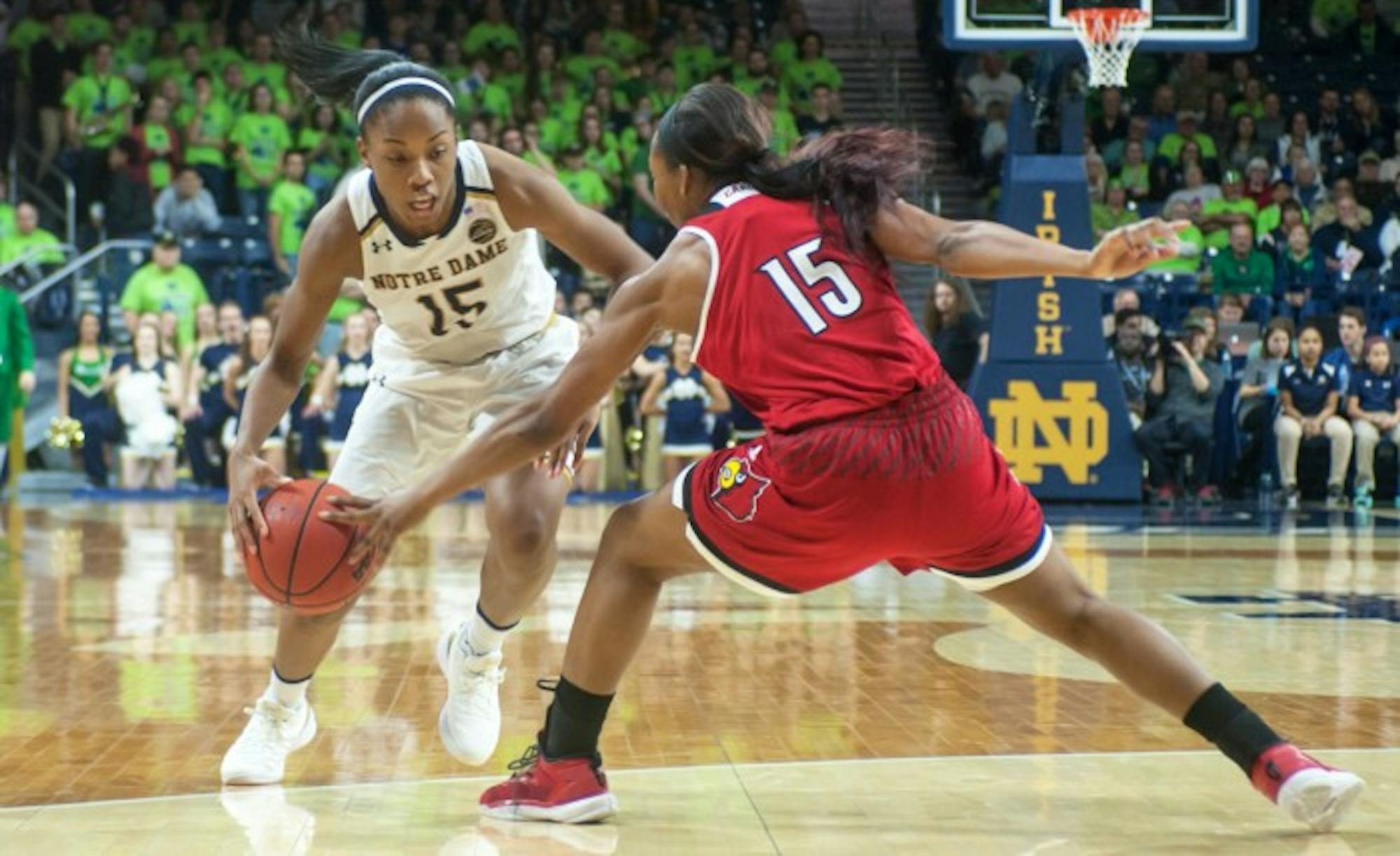 Irish senior guard Lindsay Allen drives past a Cardinal defender during Notre Dame’s 85-66 win over Louisville on Feb 6 at Purcell Pavilion. Allen finished with 15 points, a season-high, and 8 assists.