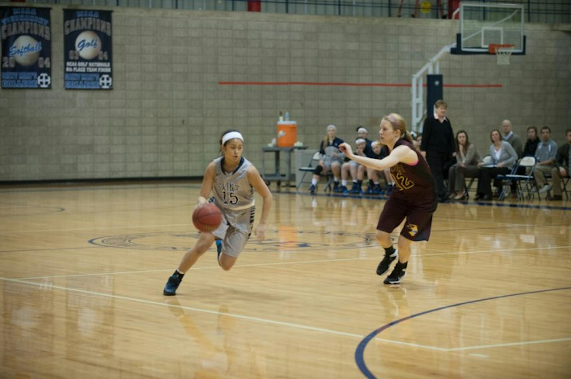 Saint Mary's freshman guard Heather Pesigan drives during the Belles' 95-68 loss to Calvin on Jan. 15.