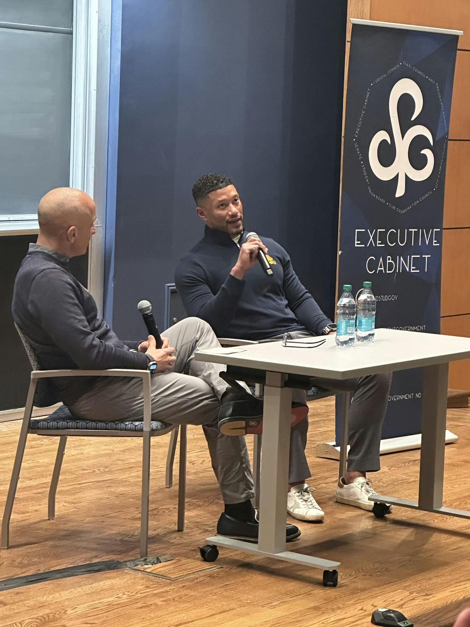 Marcus Freeman sits with Peter Bevacqua for speaker event.jpeg