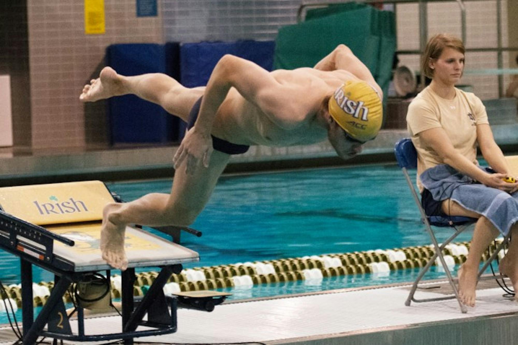 Senior Andrew Jensen dives into the pool at Rolfs Aquatic Center during a meet against Purdue on Nov. 1, 2014. The team hits the road for the first time this season when it travels to Virginia this weekend.