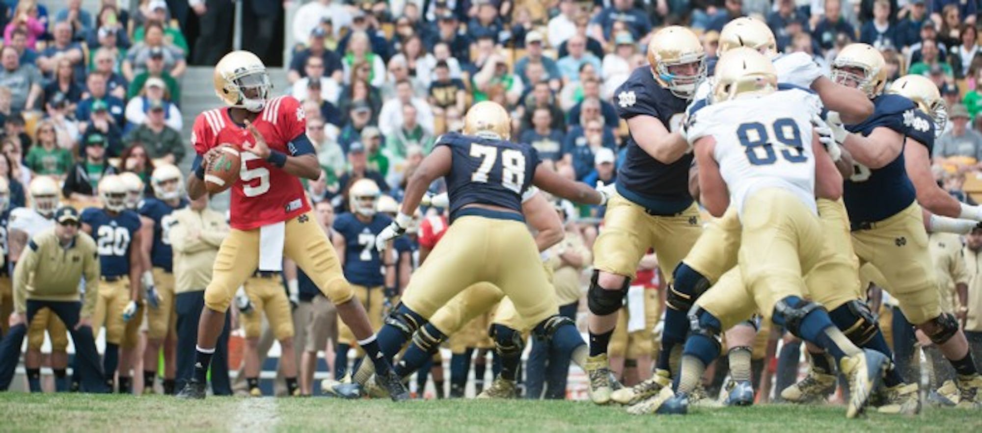 Quarterback Everett Golson, pictured in red, looks to pass during last year’s Blue-Gold  Game.   Saturday, members of the football team will compete in a friendly match-up in preparation for their 2015 season.