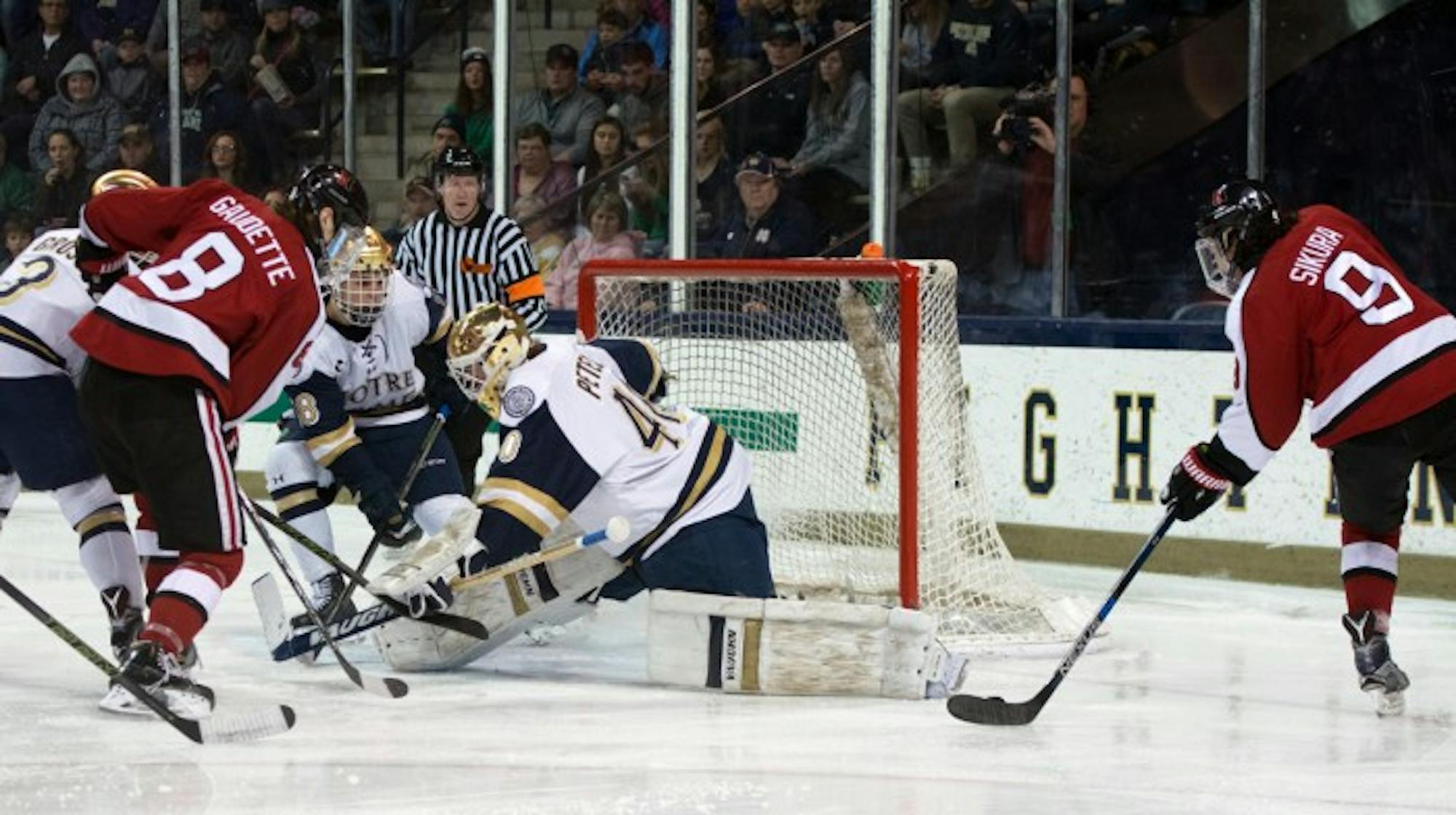Sophomore goalie Cal Petersen attempts to save a shot during Notre Dame’s 6-4 loss to Northeastern on March 12.