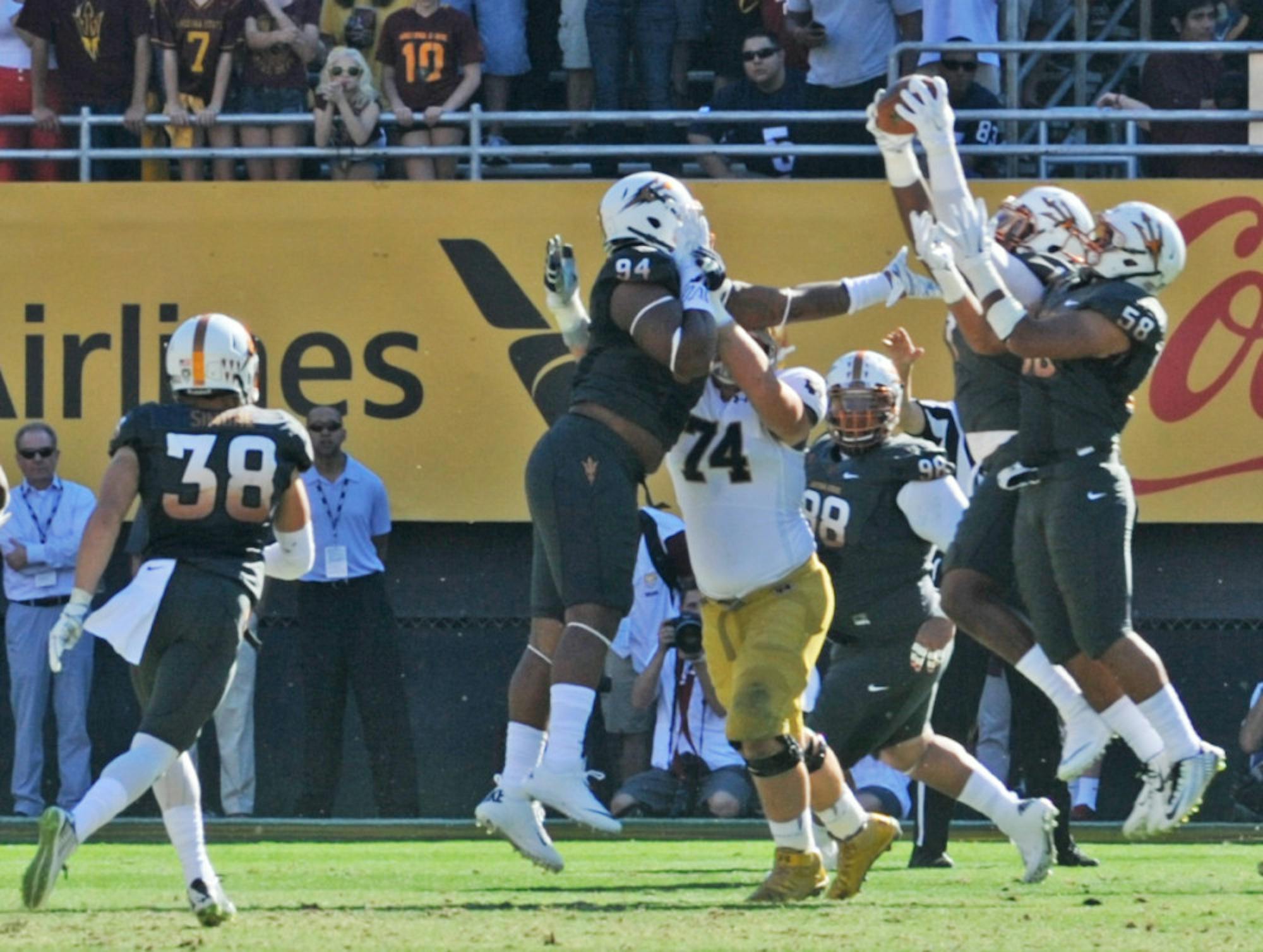 A host of Arizona State defenders reach for a deflected pass during Arizona State’s 55-31 victory over Notre Dame on Saturday. The Irish committed five turnovers in the loss.