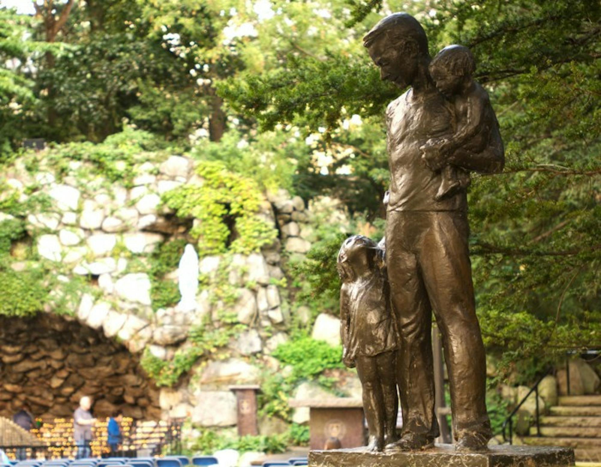 The statue of Dr. Tom Dooley stands against the backdrop of the Grotto. Affixed to the statue is a letter from Dooley to University President Emeritus Fr. Theodore Hesburgh, written more than 50 years ago.