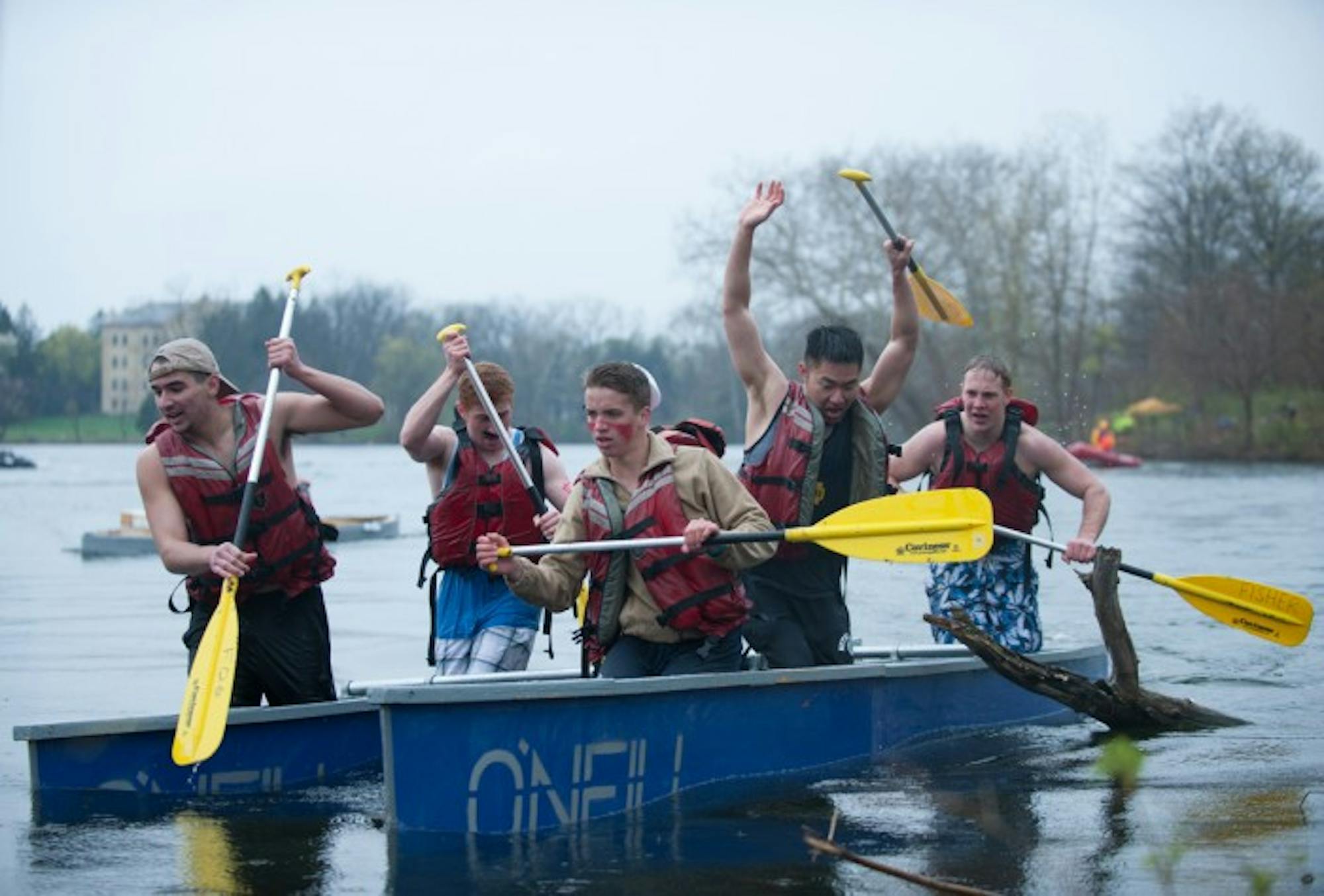 Residents of O'Neil Hall paddle their handmade boat for the 25th annual Fisher Regatta.