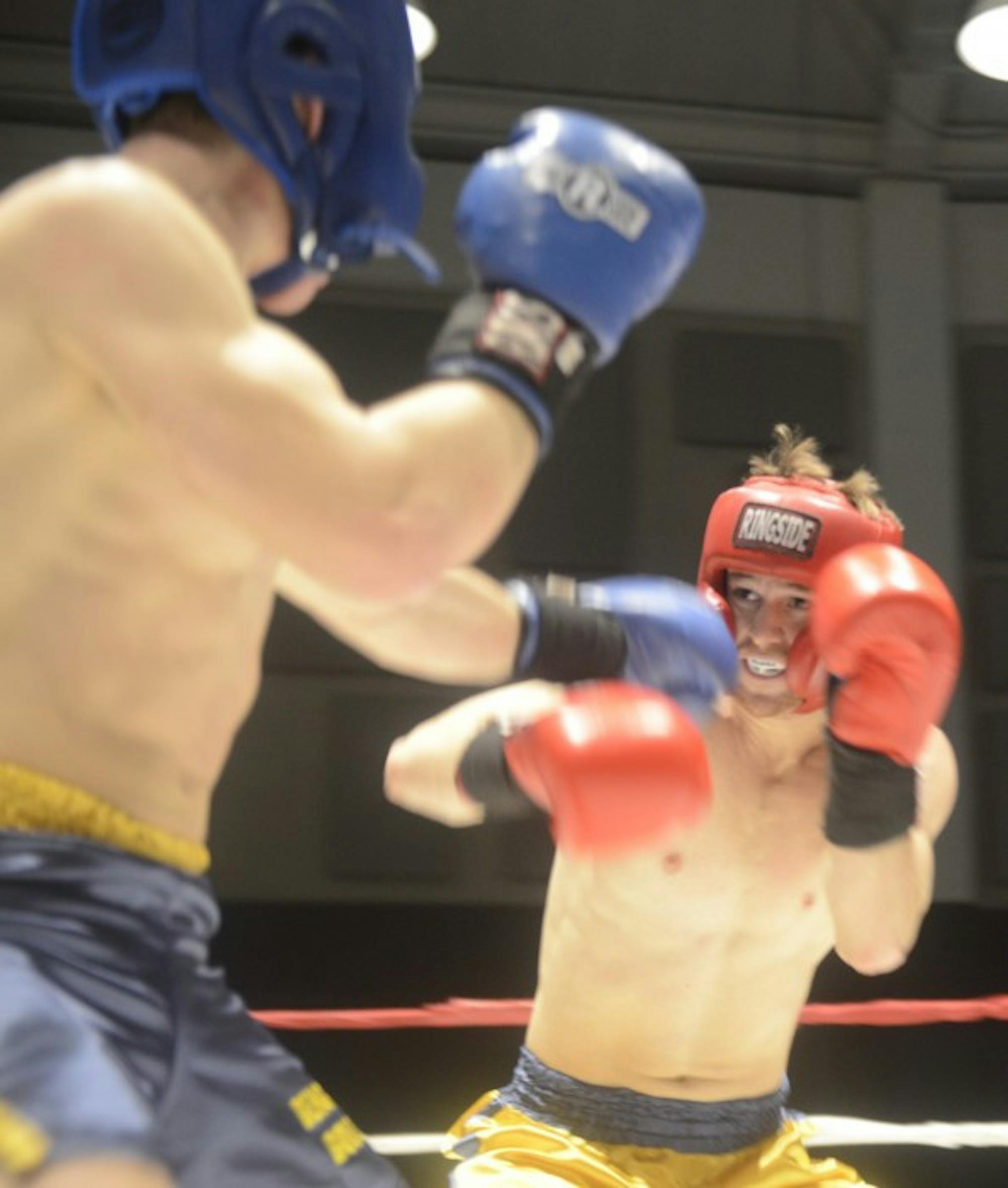 Senior Chip Blood, in gold, fights against freshman Parker