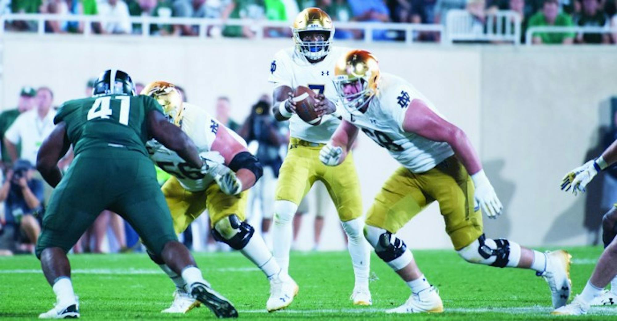 Irish junior quarterback Brandon Wimbush handles the snap during Notre Dame's 38-18 win over Michigan State on Saturday in East Lansing, Michigan.