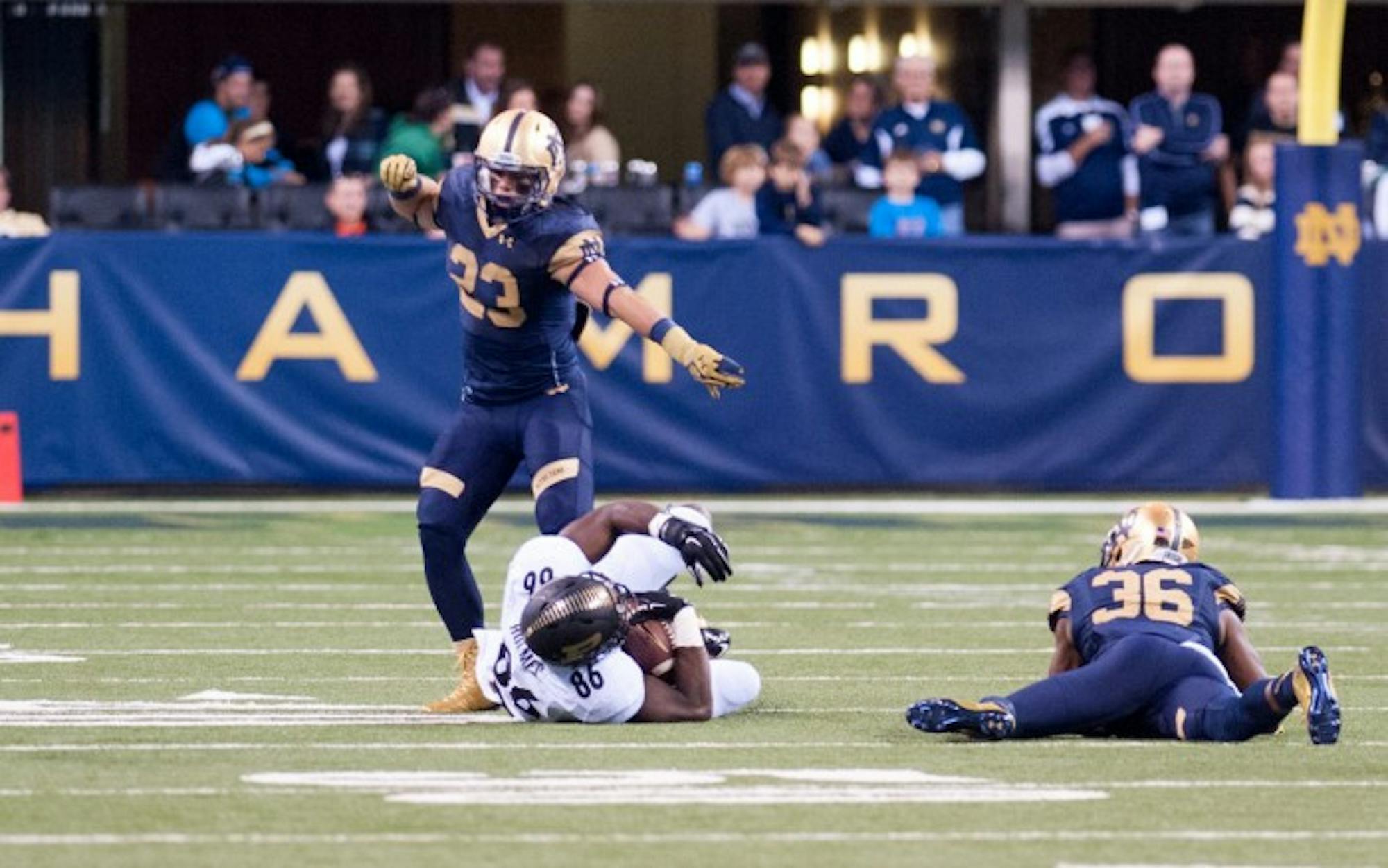 Irish freshman safety Drue Tranquill, 23, backs up sophomore cornerback Cole Luke on a tackle during Notre Dame's 30-14 win over Purdue on Sept. 13 at Lucas Oil Stadium.