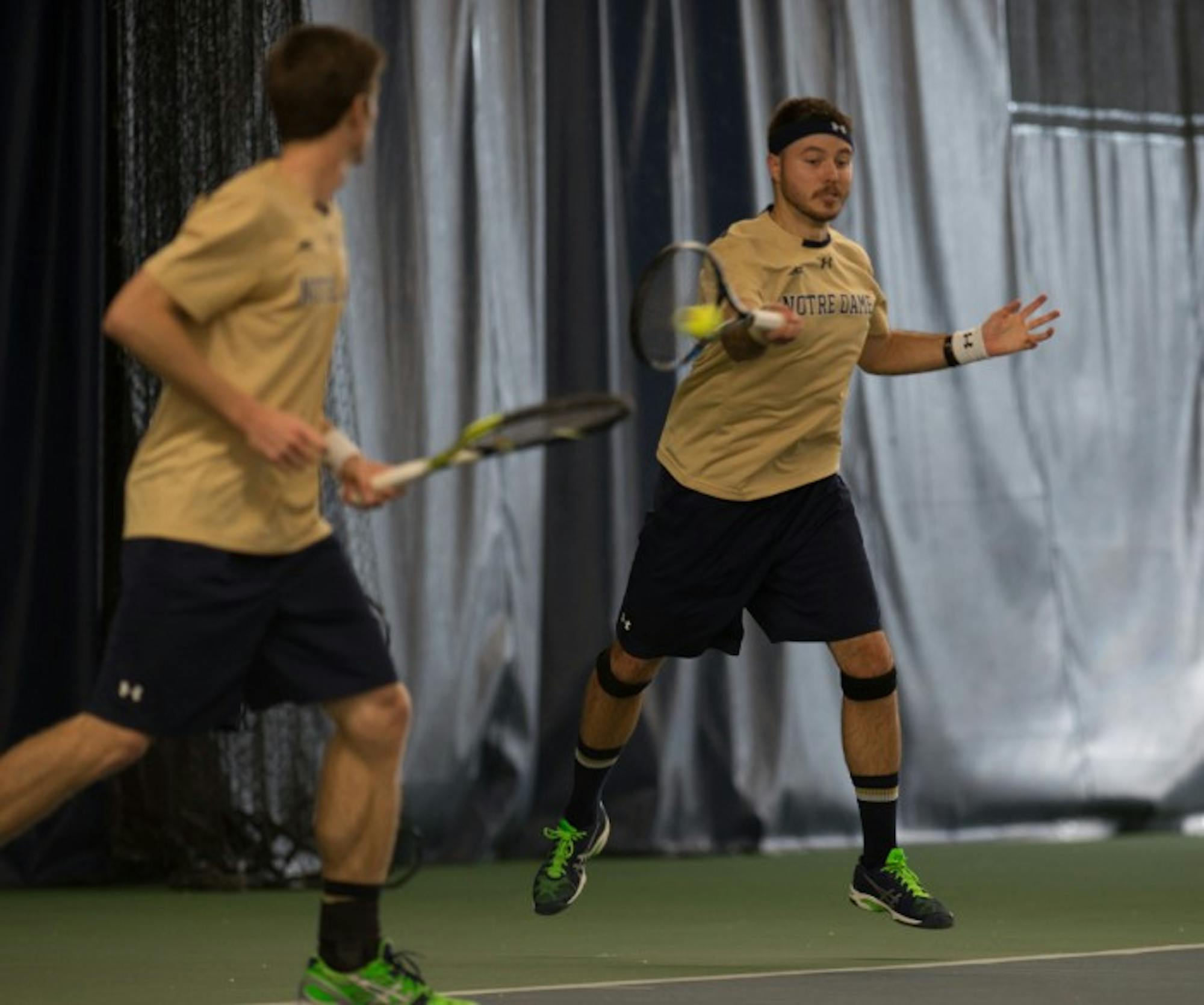 Irish senior Billy Pecor, right, connects on a shot during Notre Dame's 4-3 win over Oklahoma State on Jan. 24 at Eck Tennis Pavilion.