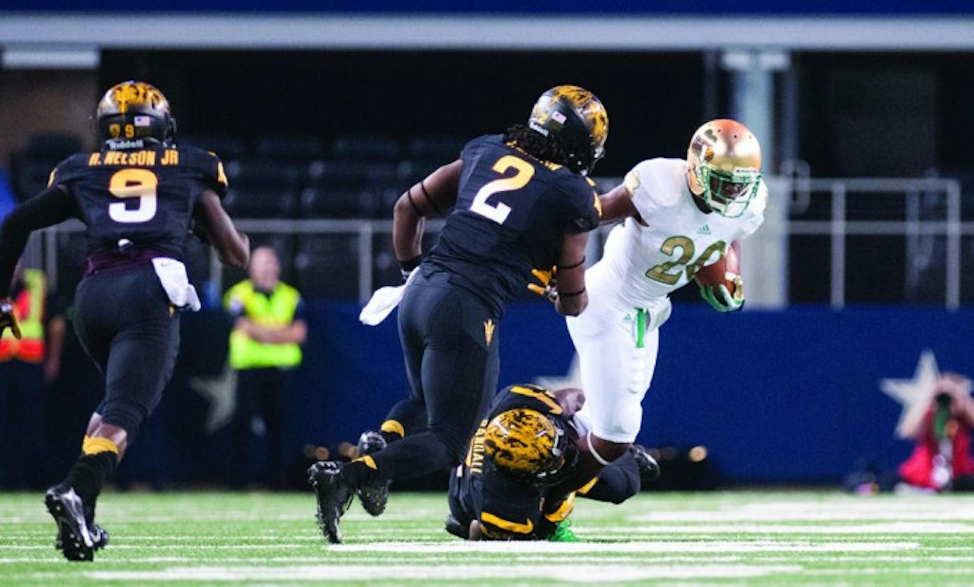 Irish senior running back C.J. Prosise tries to break an Arizona State tackle during Notre Dame’s 37-34 win over the Sun Devils on Oct. 5, 2013. The game, part of Notre Dame’s annual Shamrock Series, took place at AT&T Stadium in Arlington, Texas, home of the Dallas Cowboys.