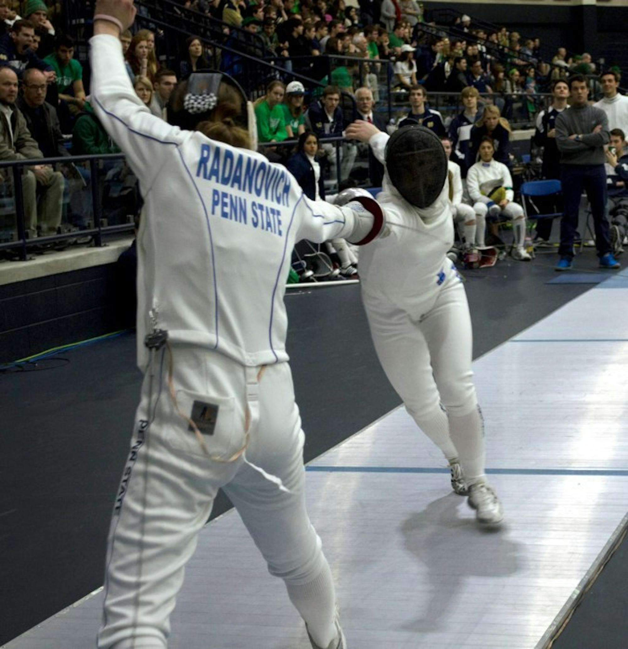 Irish junior epeeist Catherine Lee thrusts at Penn State  sophomore Jessie Radanovich during last year’s       DeCicco Duels at the Castellan Family Fencing Center on Feb. 8. ND defeated the Nittany Lions, 14-13.