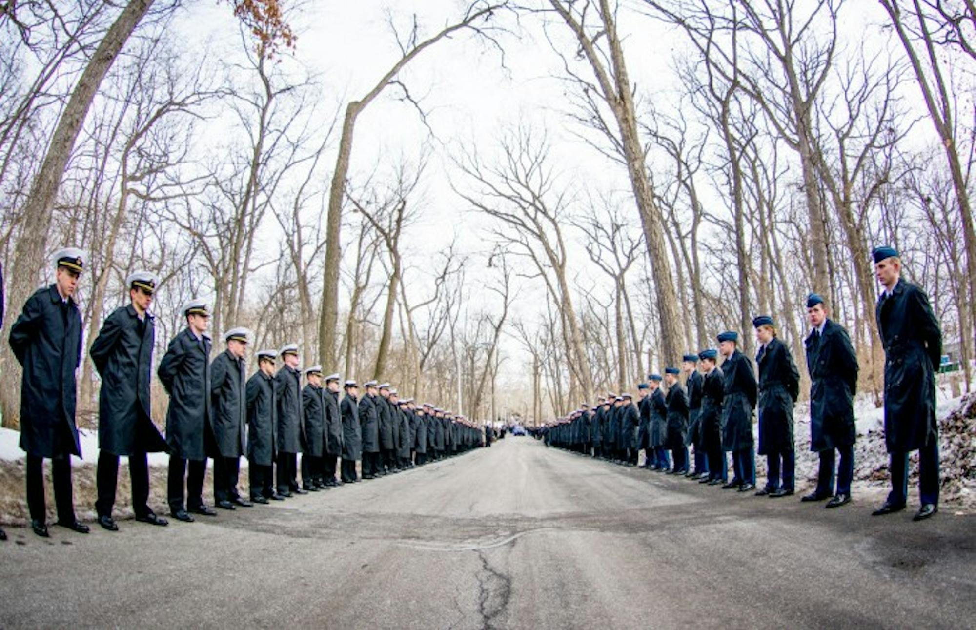 University midshipmen (left) and cadets (right) line Saint Mary’s Road to honor the life of Fr. Hesburgh during the funeral procession March 4. Many students, faculty and staff joined the procession.