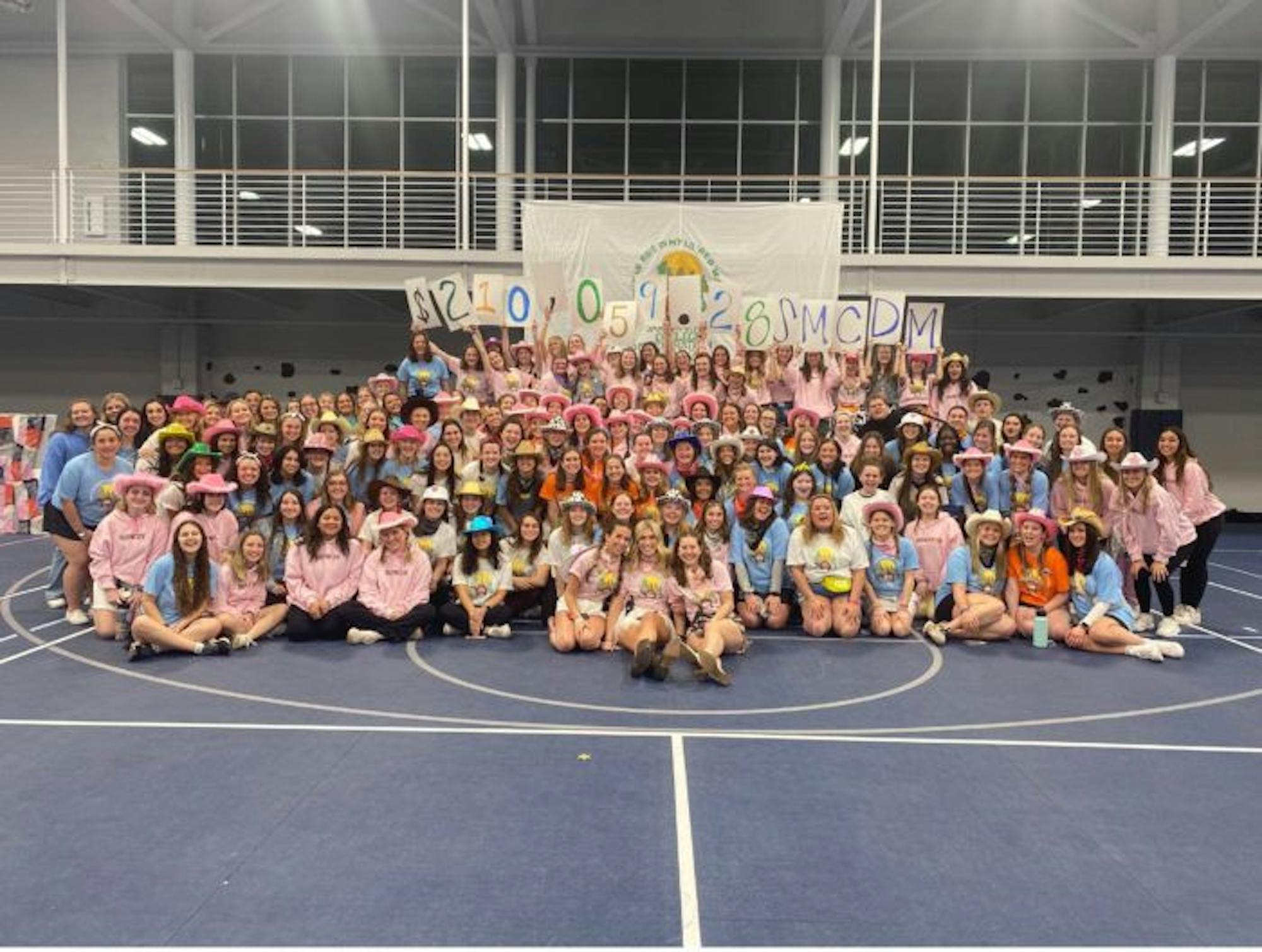After 12 hours of dancing and fundraising for Riley Children's Hospital the Saint Mary's College Dance Marathon members and participants pose with final donation total.