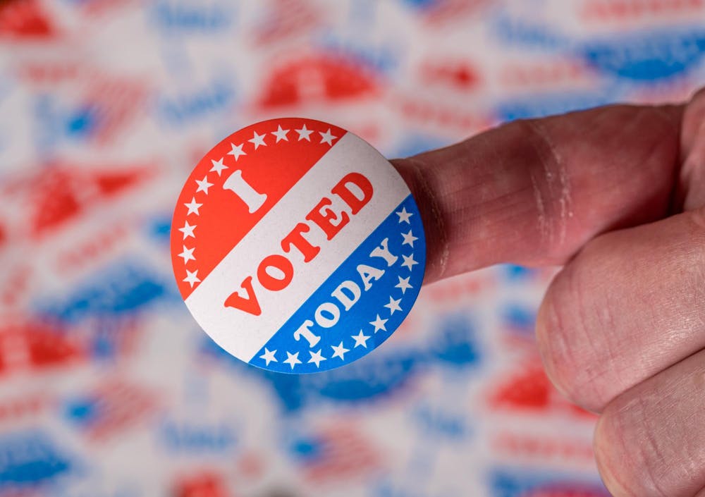 vecteezy_finger-with-i-voted-today-sticker-in-front-of-background_7221341.jpg
