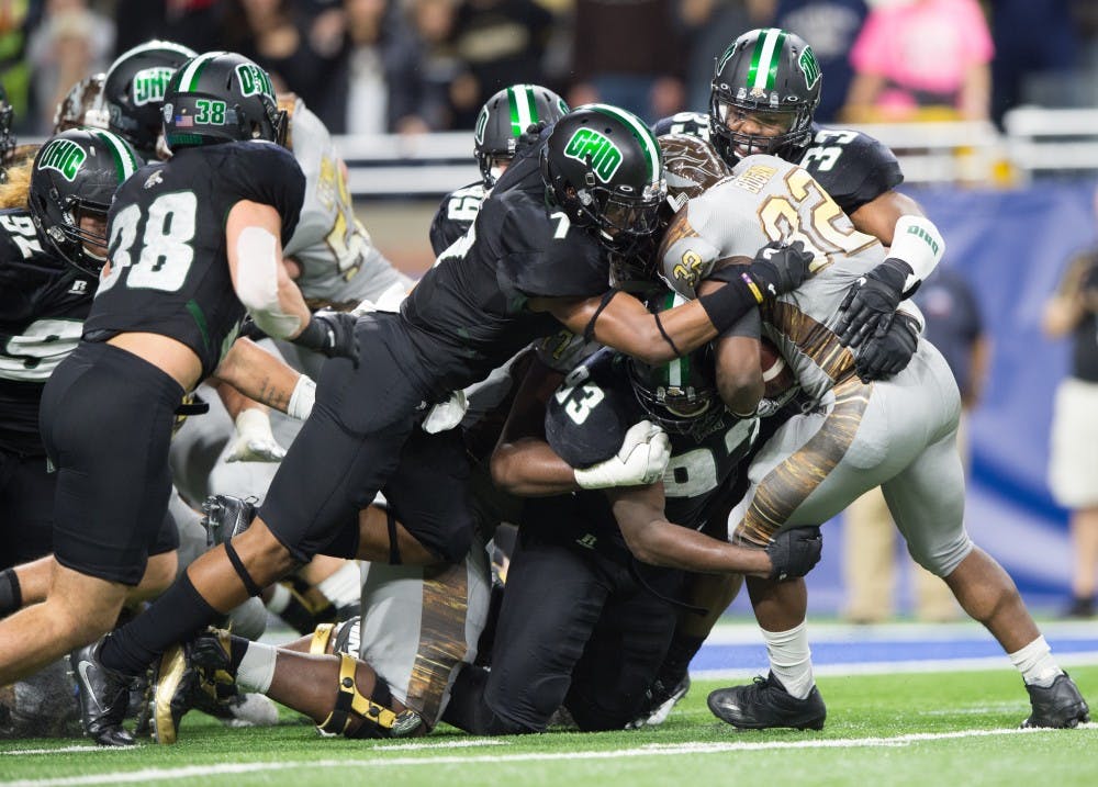 Tarell Basham (93) and Javon Hagan (7) make a goal- line stop against Western Michigan on Ford Field in Detroit Friday night MATT STARKEY|STAFF PHOTOGRAPHER