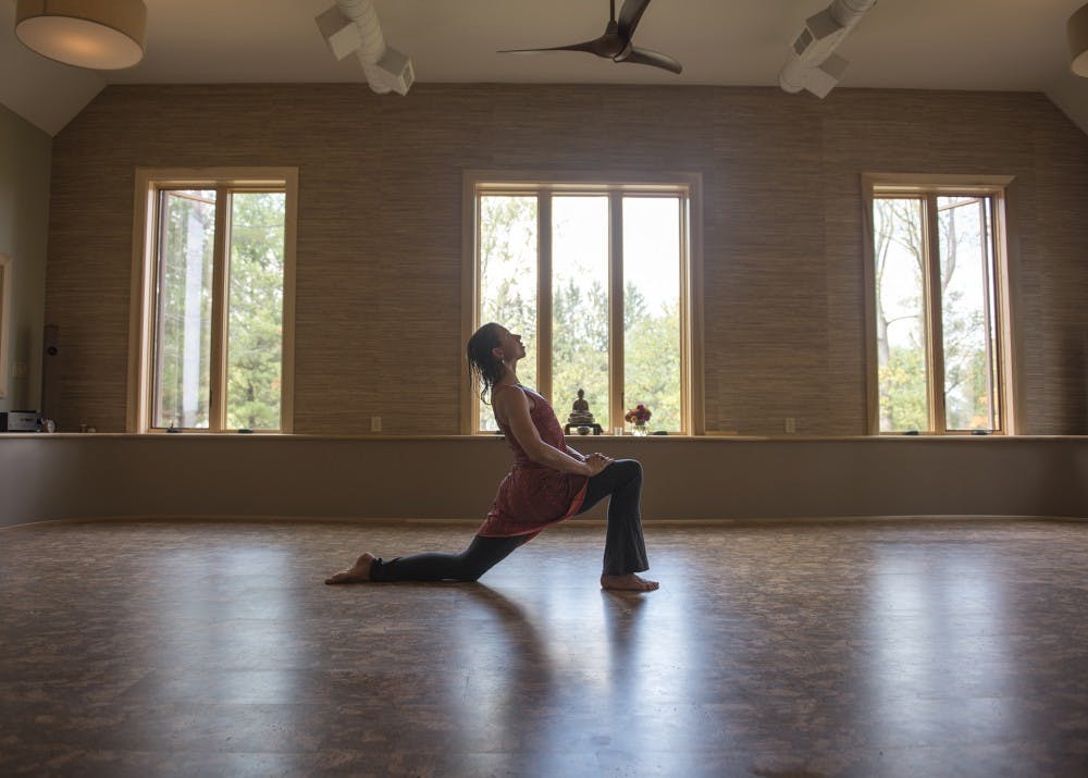 Owner Liz Chamberlain goes through yoga poses in her yoga studio at Bodhi Tree Guesthouse and Studio on 8950 Lavelle Road in Athens. Liz started Bodhi Tree back in 2014 with her husband.