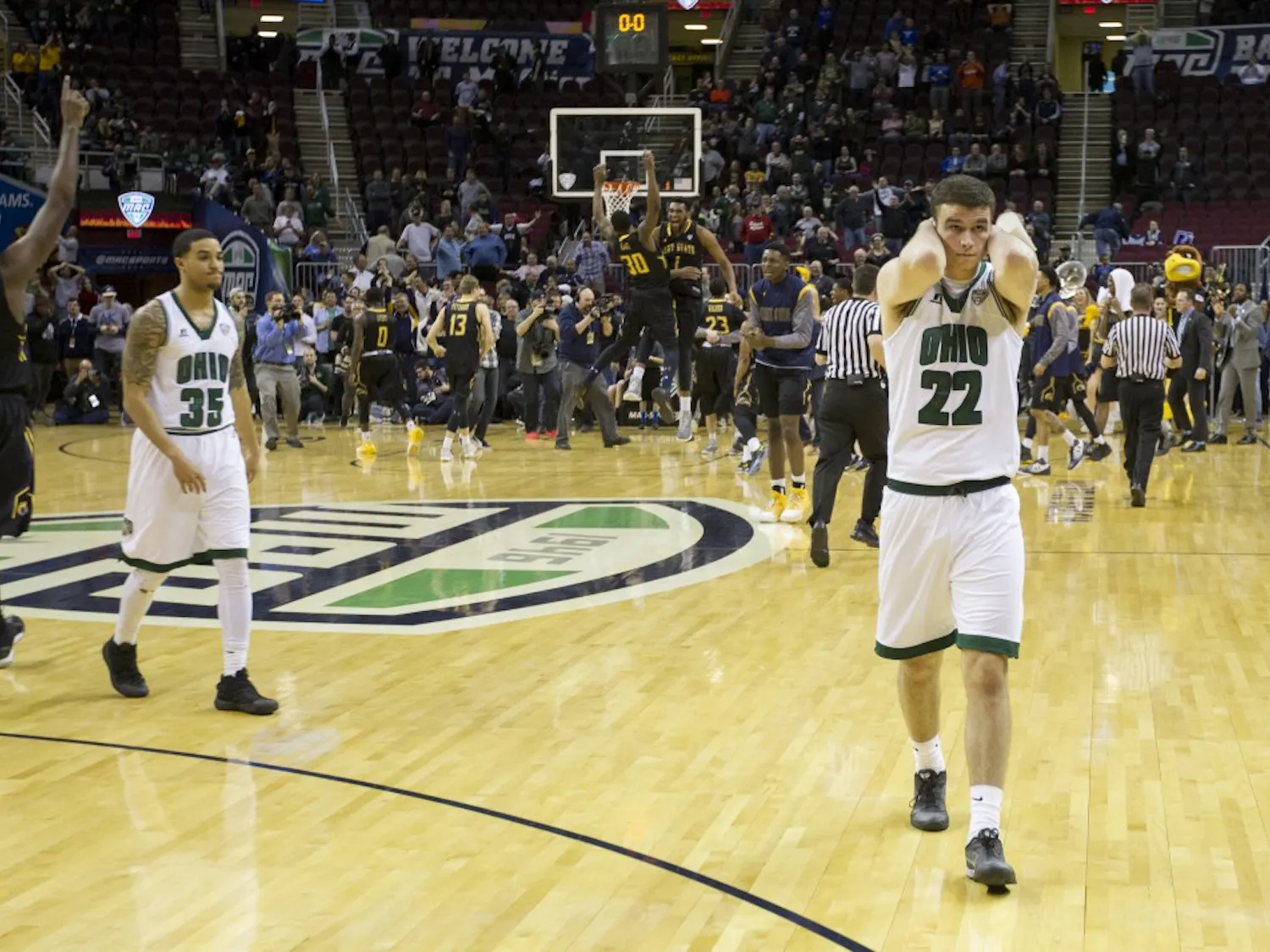 Ohio sophomore forward Gavin Block (#22) and sophomore guard Jordan Dartis (#35) walk off the court after losing to Kent State 68-66 in the MAC Tournament semifinals on Friday, March 10, 2017.