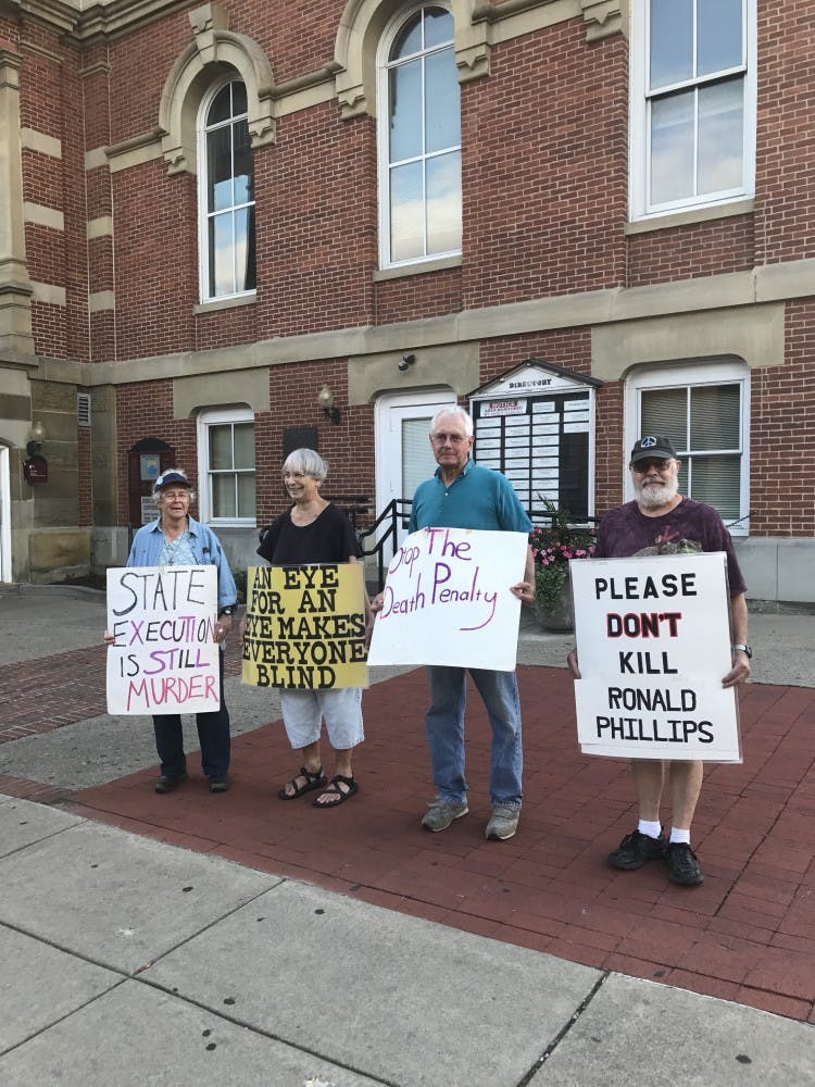 Four protesters gathered Tuesday evening at the&nbsp;Athens County Courthouse.&nbsp;