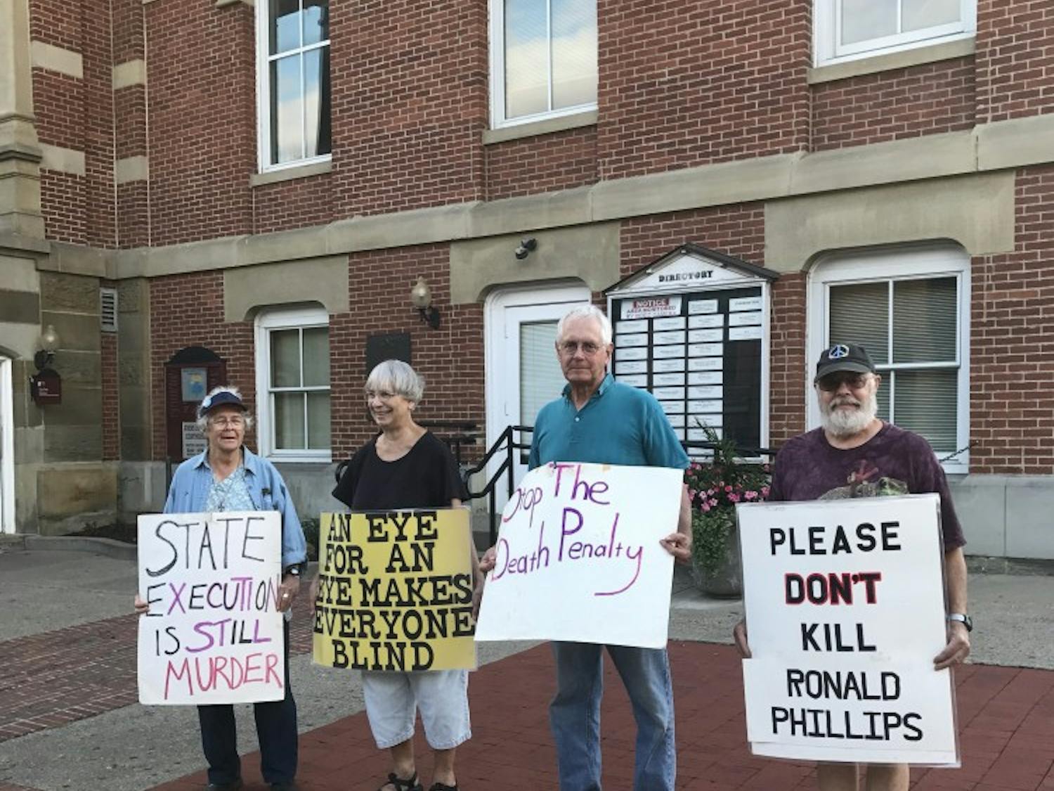 Four protesters gathered Tuesday evening at the&nbsp;Athens County Courthouse.&nbsp;