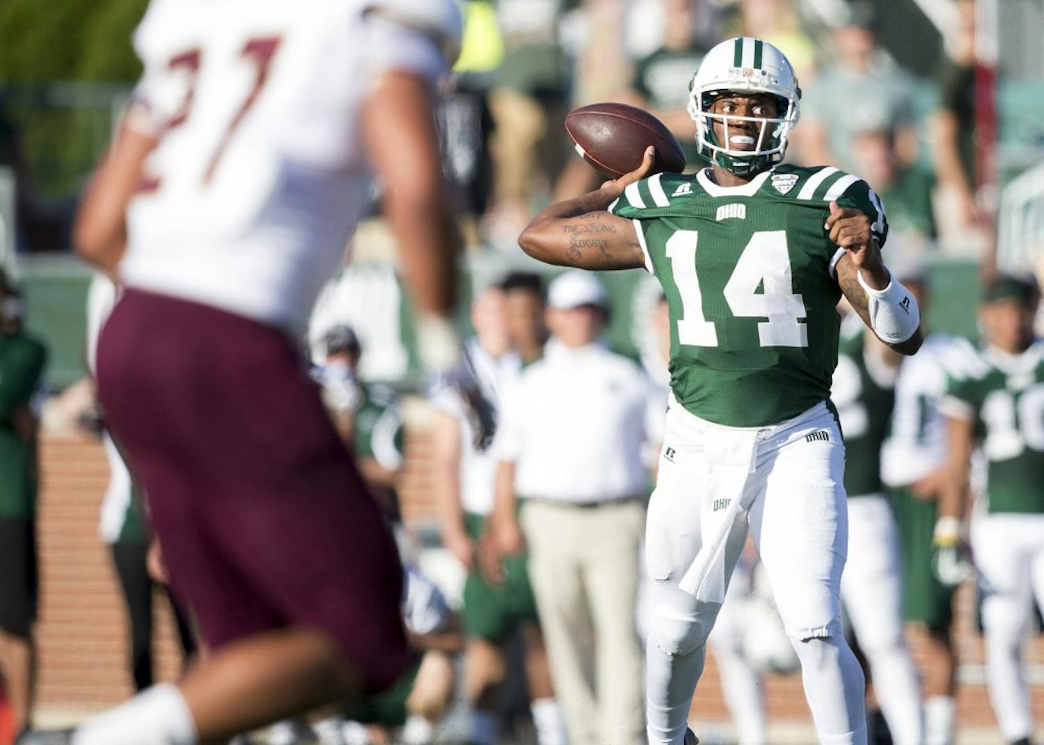 Ohio redshirt senior quarterback Greg Windham (#14) passes downfield against Texas State on Saturday, September 3, 2016. Windham passed for 308 yards in his first game as starting quarterback. 