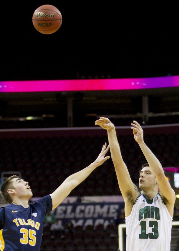 Ohio redshirt senior forward Kenny Kaminski (#13) puts up a shot over Toledo sophomore forward Nate Navigato (#35) during the first half of the Bobcat's comeback win over the Rockets on Thursday, March 9, 2017. 