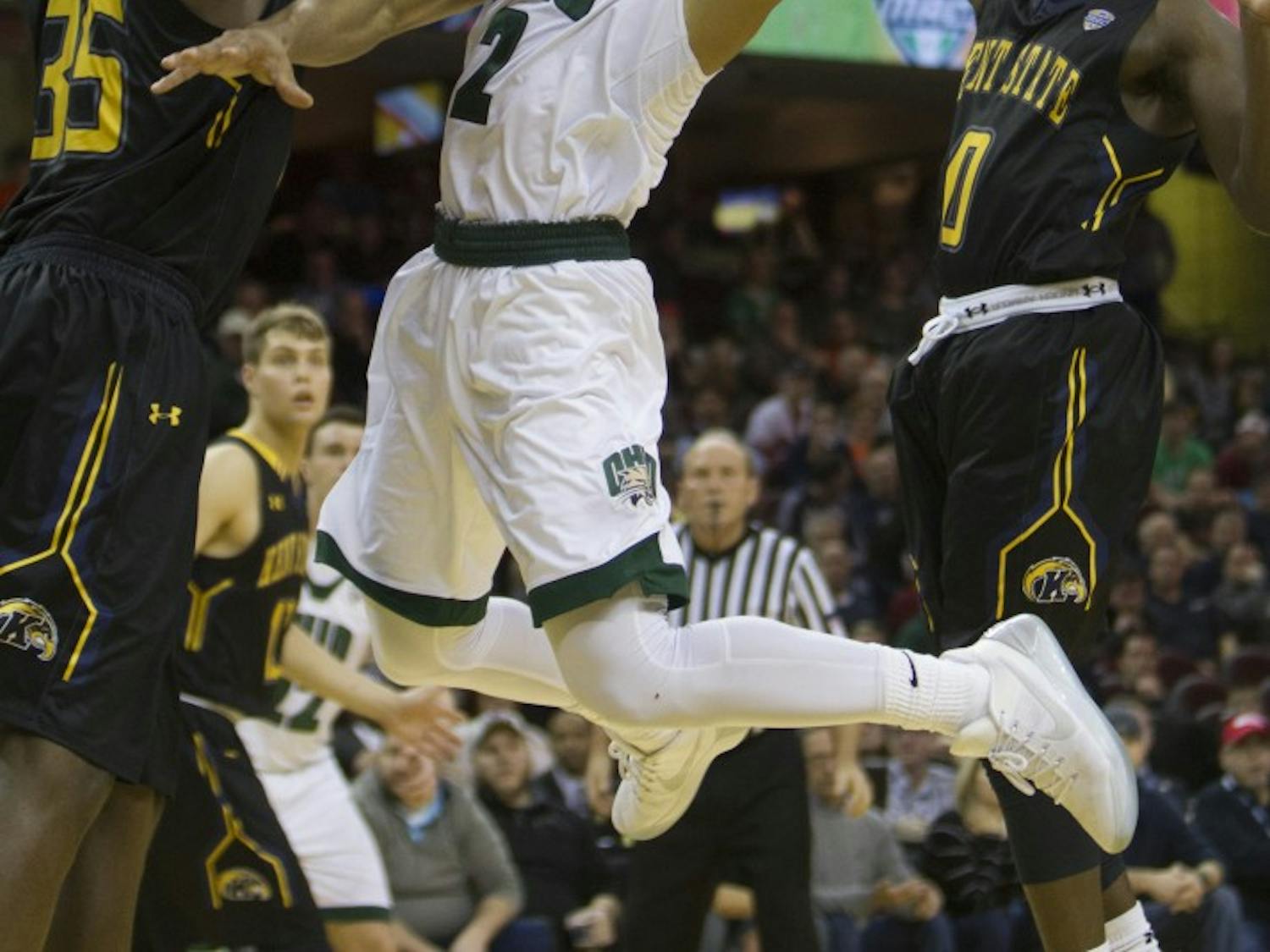 Ohio redshirt junior guard Jaaron Simmons (#2) goes up for a layup around two Kent State defenders during the second half of the Bobcat's 68-66 loss in the MAC Tournament semifinals. 