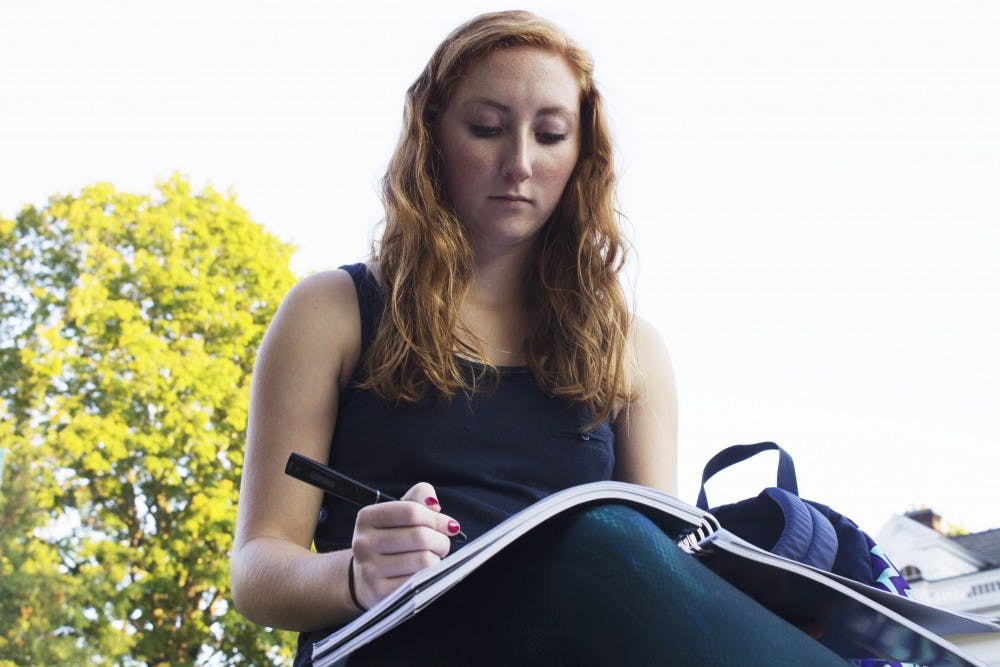 Maddie Knostman, a freshman studying visual communications with dyxlexia, writing notes. Knostman was diagniosed her sophmore year of highschool. (LAILA RIAZ | FOR THE POST)