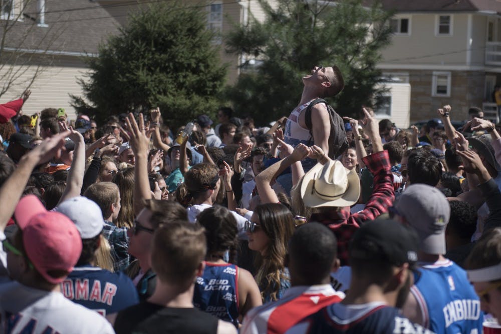 A partier is lifted above a crowd of fest participants outside of Palmer Place during Palmer Fest on April 8, 2017.