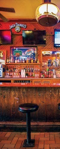 Band plays music at show in bar, attendees listen to music played  