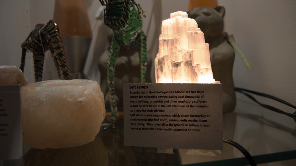 Import House on Court Street sells Himalayan salt lamps, featuring a sign giving a descprition of where the lamps originate and how they are thought to work. 