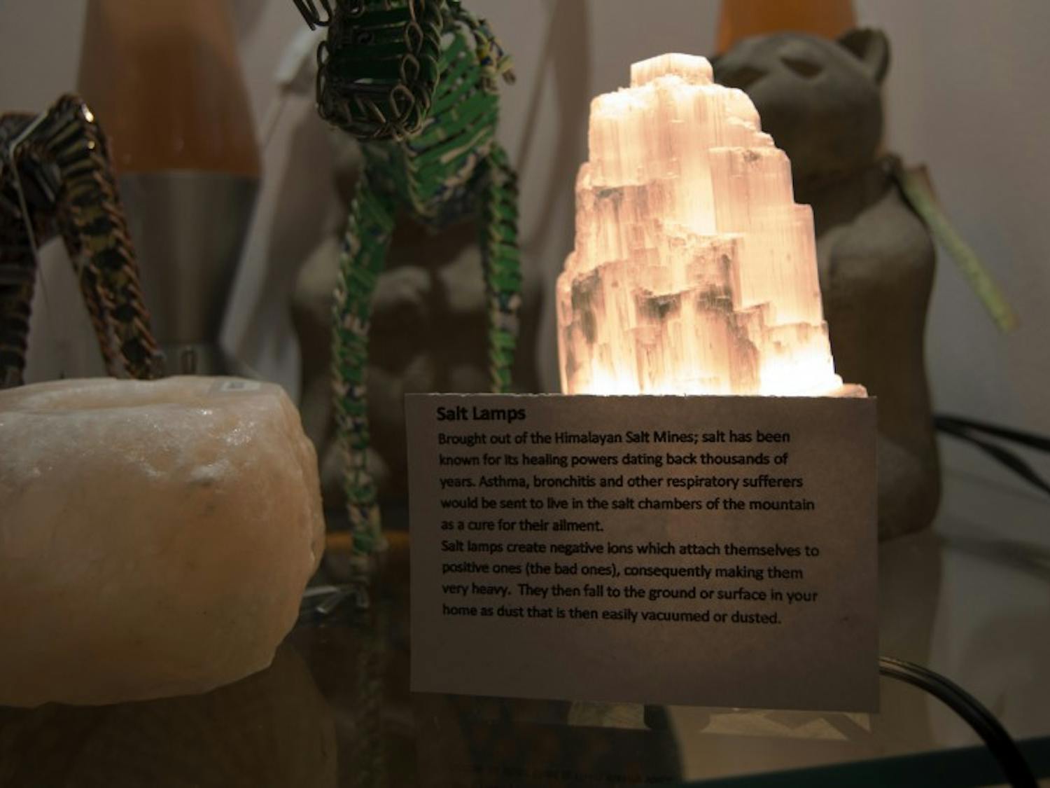 Import House on Court Street sells Himalayan salt lamps, featuring a sign giving a descprition of where the lamps originate and how they are thought to work. 