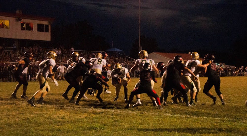 Athens High School quarterback Brandon Sano carries the ball. Sano would go on to finish the game with 14 carries, 82 yards and two rushing touchdowns.