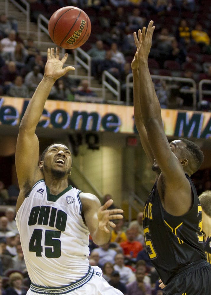 Ohio sophomore forward Doug Taylor (#45) puts up a shot over a Kent State defender during the second half of the Bobcat's 68-66 loss on Friday, March 10, 2017. Taylor finished with eight points off the bench.