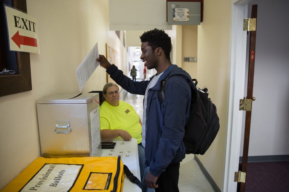 Austin Rivers, a senior from South Carolina, drops his vote in the ballot box on Tuesday. (LIZ MOUGHON | PHOTO EDITOR)