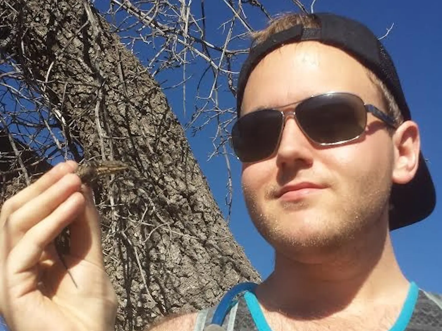 Anthony Gilbert, a fourth year doctorate student, poses with a reptile.