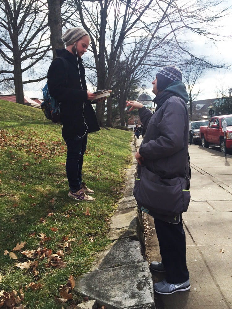 Monk distributing books  
