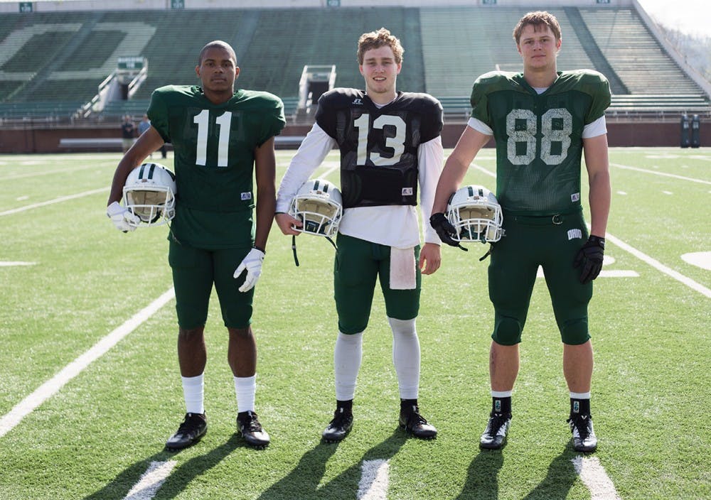 From left to right, freshman wide receiver Willie Cherry, freshman quarterback Deeb Haber, and freshman tight end Ryan Luehrman pose for a portrait at Peden Stadium on April 12, 2017. (EMILY MATTHEWS | PHOTO EDITOR) 