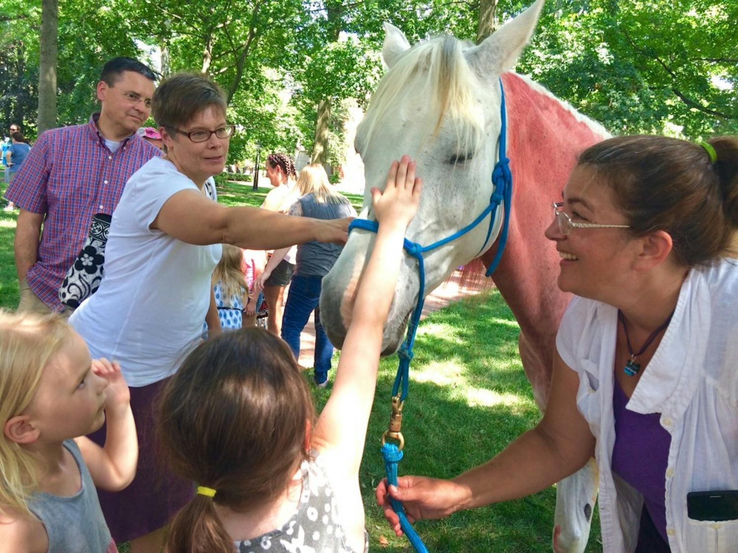 Children and adults pet Emma, a rainbow horse, during&nbsp;Athens Pride Fest 2017