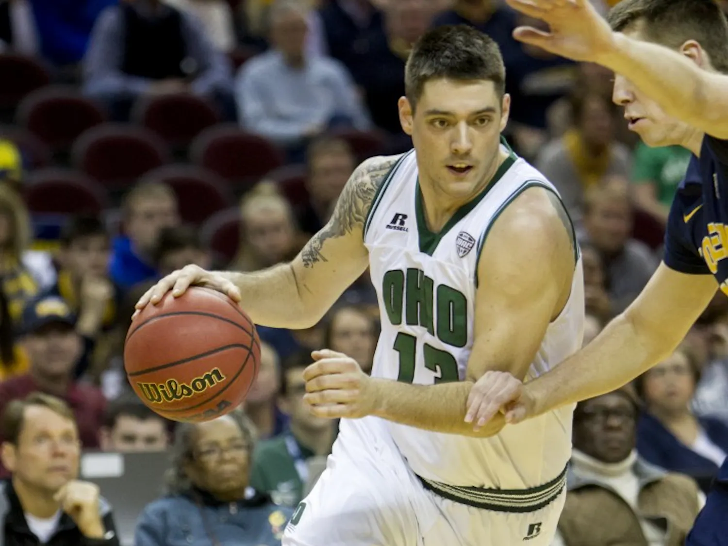 Ohio redshirt senior forward Kenny Kaminski (#13) drives past a Toledo defender during the first half of the Bobcat's come-from-behind 67-66 win over Toledo on Thursday, March 9, 2017. Kaminski hit a shot from the key with seven seconds left for his second game-winning shot of the season.