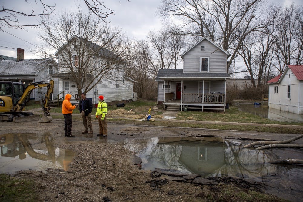 Athens City engineer Andy Stone talks with crews as they respond to a water main break that started around 5 a.m. Thursday on West State Street.