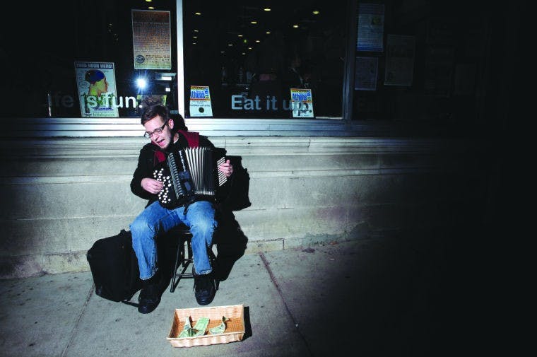 Performer trades toy for money-making accordion  