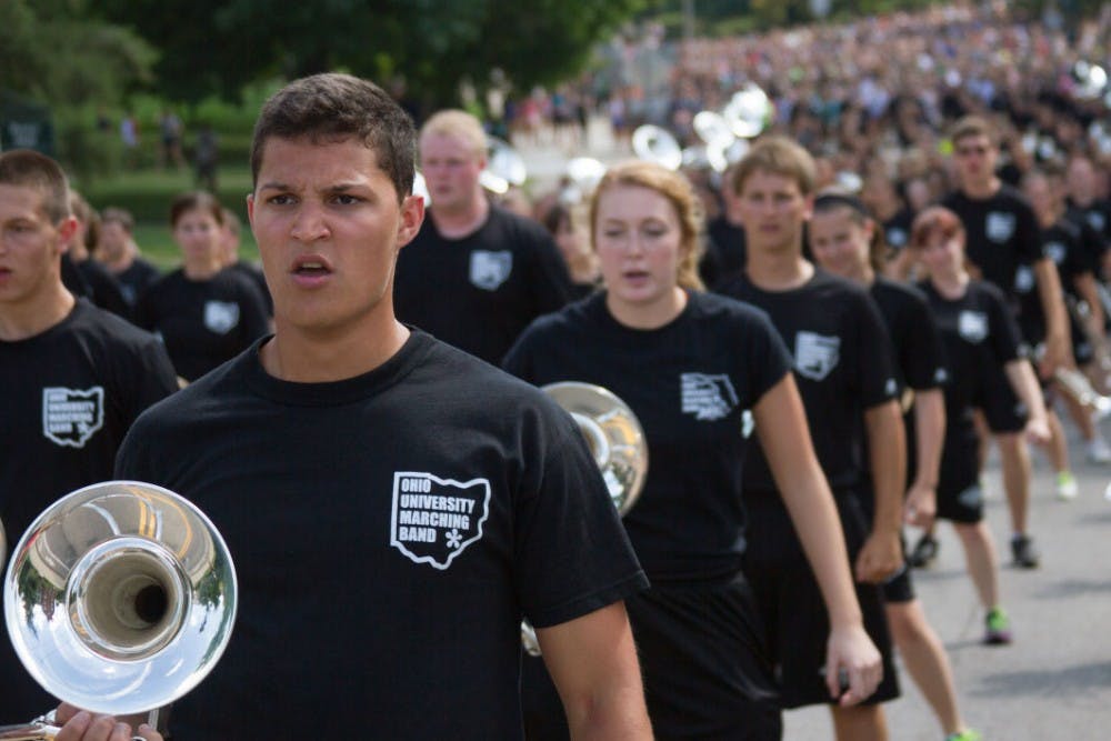 Marching 110 lead the freshmen parade  