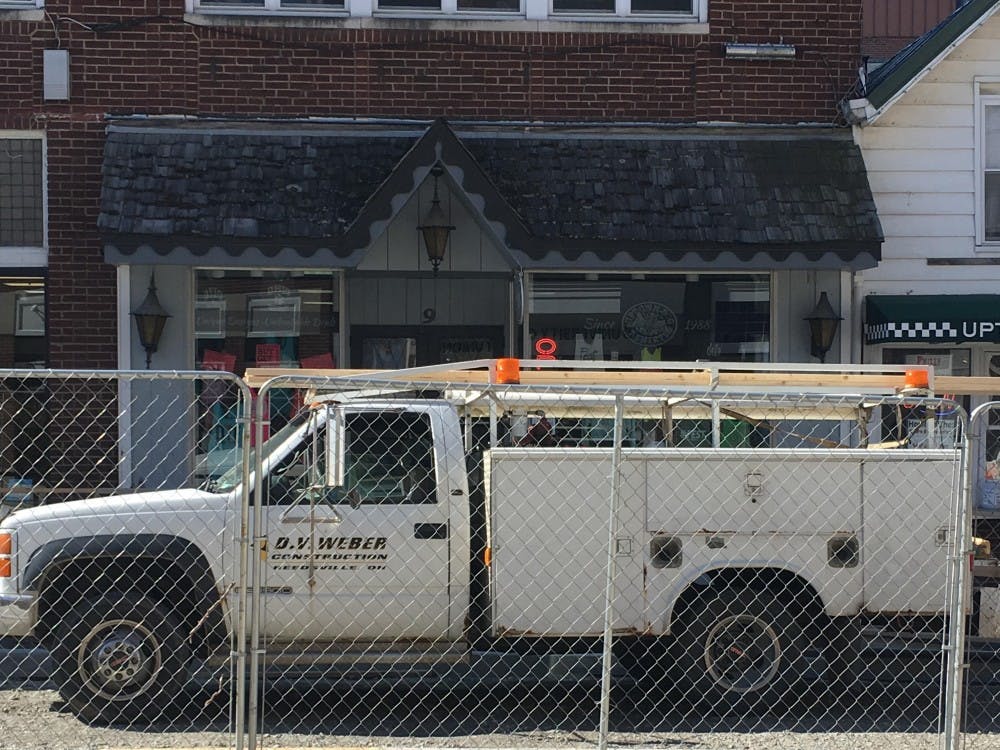 A construction vehicle visually blocks the storefront of Uptown Dog T-Shirts, 9 W. Union St. (provided via Mary Cheadle)