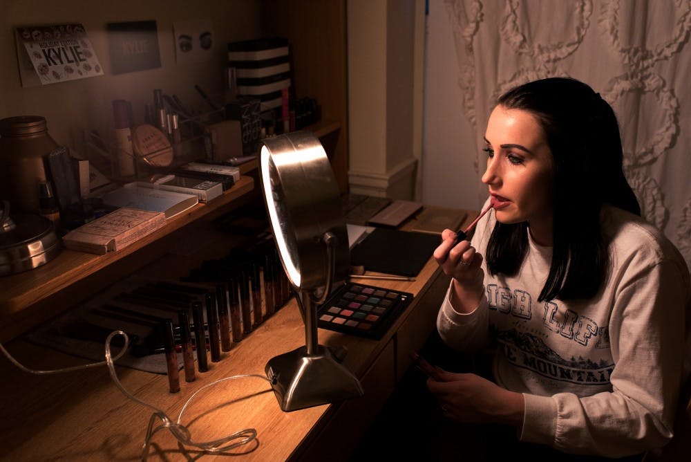 Abigail Patsiavos, an undecided freshman, reapplies Kylie Lip Kit liquid lipstick in her room on November 29, 2016. (EMMA HOWELLS | PHOTO EDITOR)