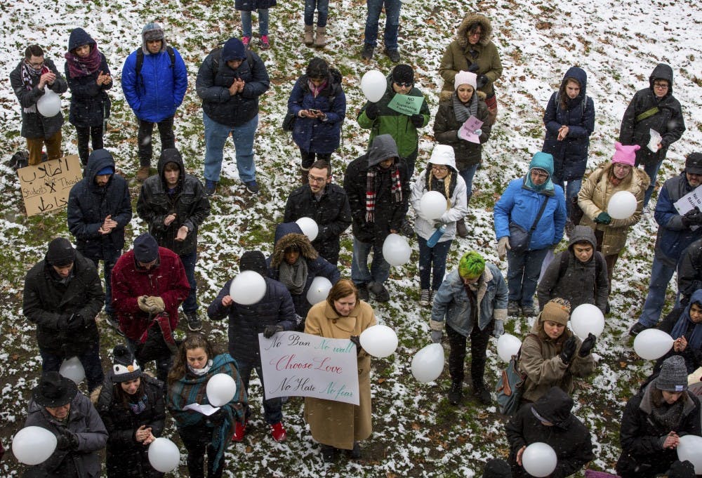 Students, faculty and community members gather on a snowy College Green near Templeton-Blackburn Alumni Memorial Auditorium during an Academics United - No Visa and Immigration Ban rally on Feb. 9. Rallies took place on more than 50 campuses across the U.S., according to the Facebook event.